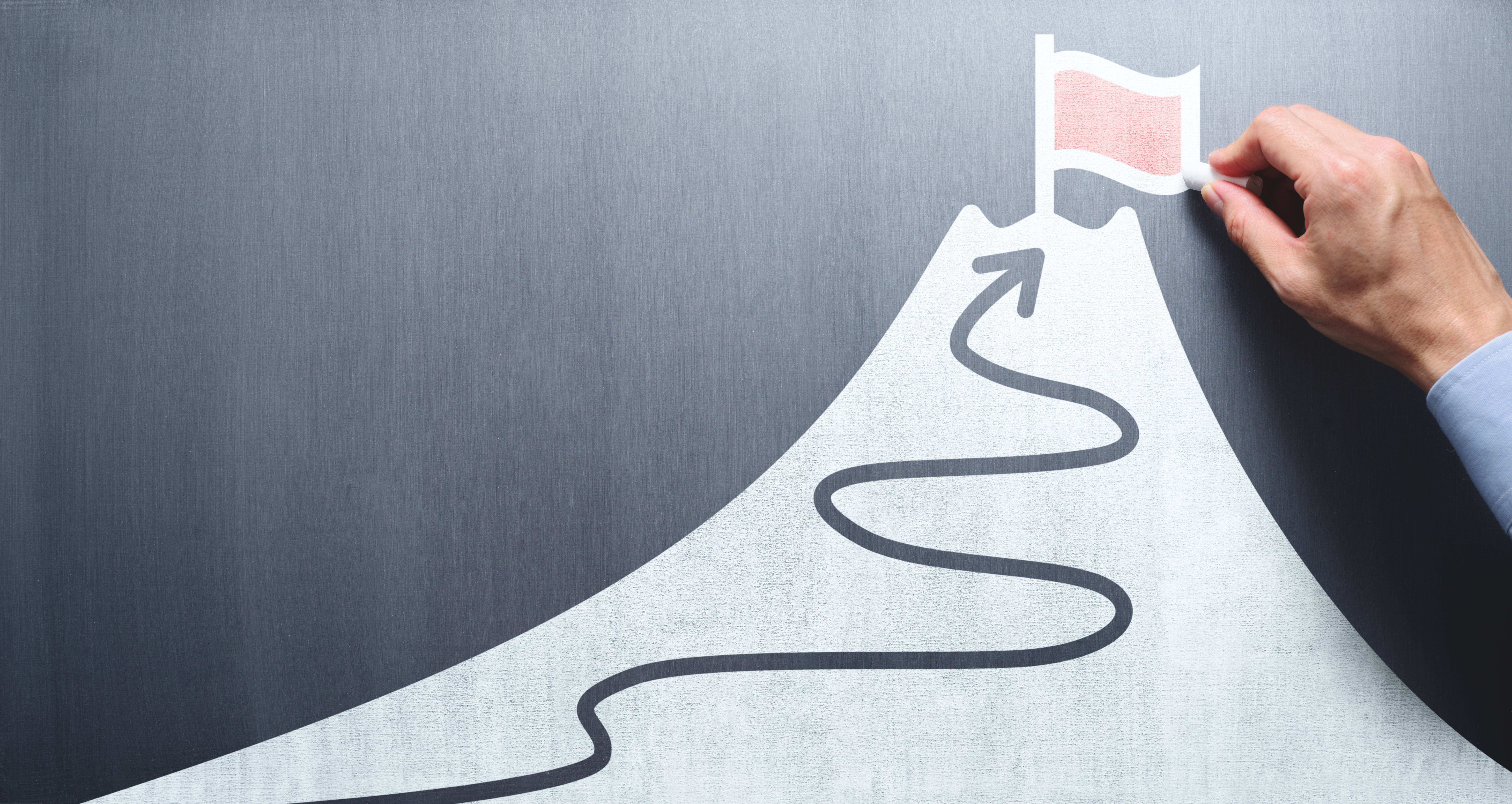 grey background with a drawn arrow winding up a drawn light grey mountain with a hand putting a red flag on top