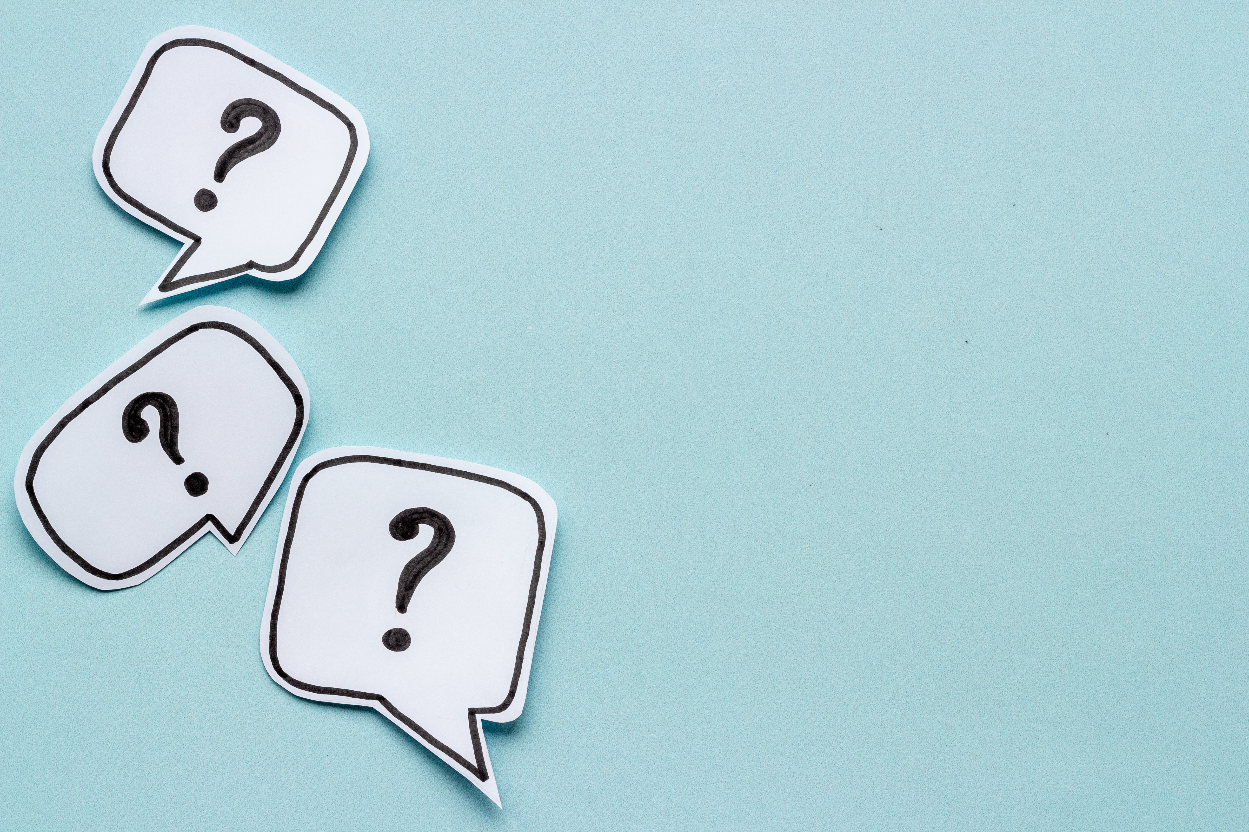 Blue background image with three speech bubbles with a question mark on the inside